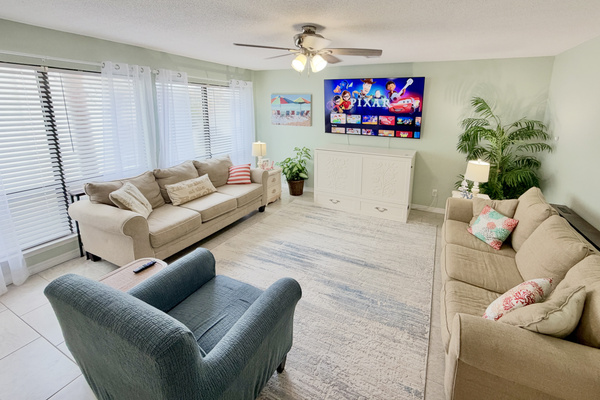 Open-concept living room complete with a 75" UHD Roku Smart TV. Bring those streaming credentials.