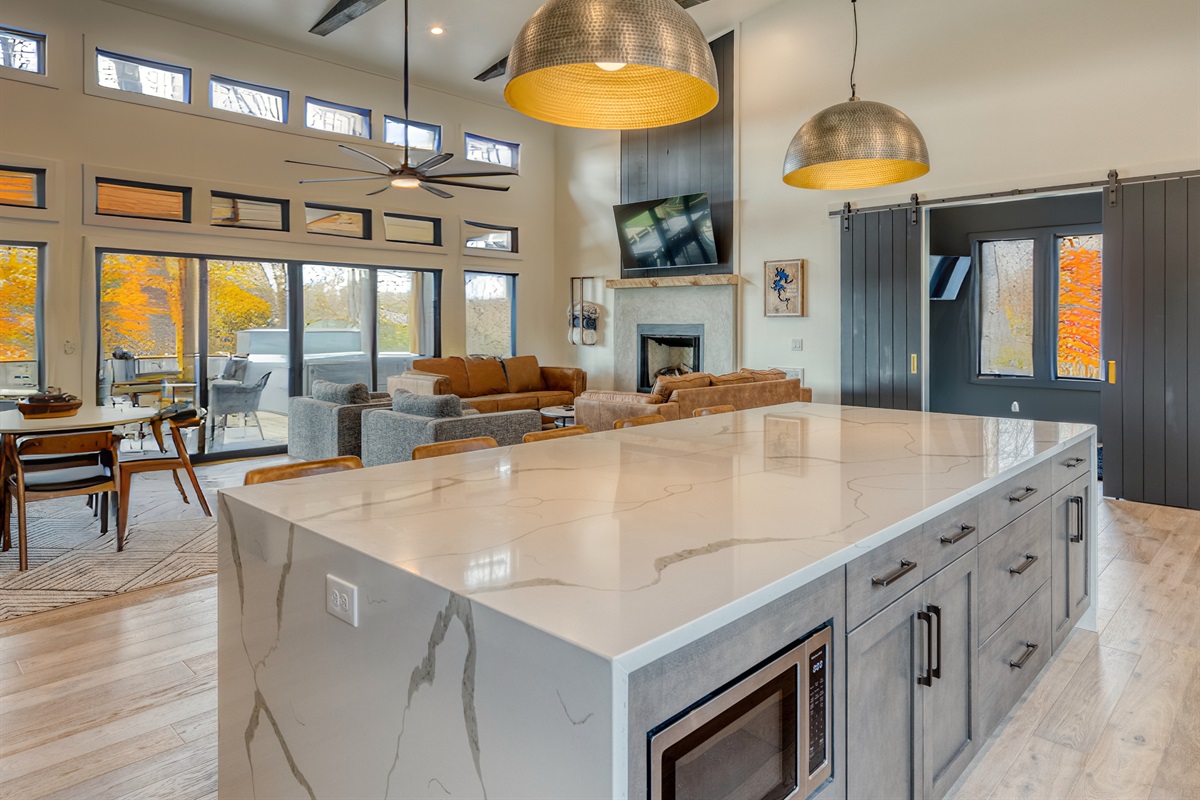 An overall view of the modern kitchen and living area, blending contemporary design with a cozy cabin vibe.