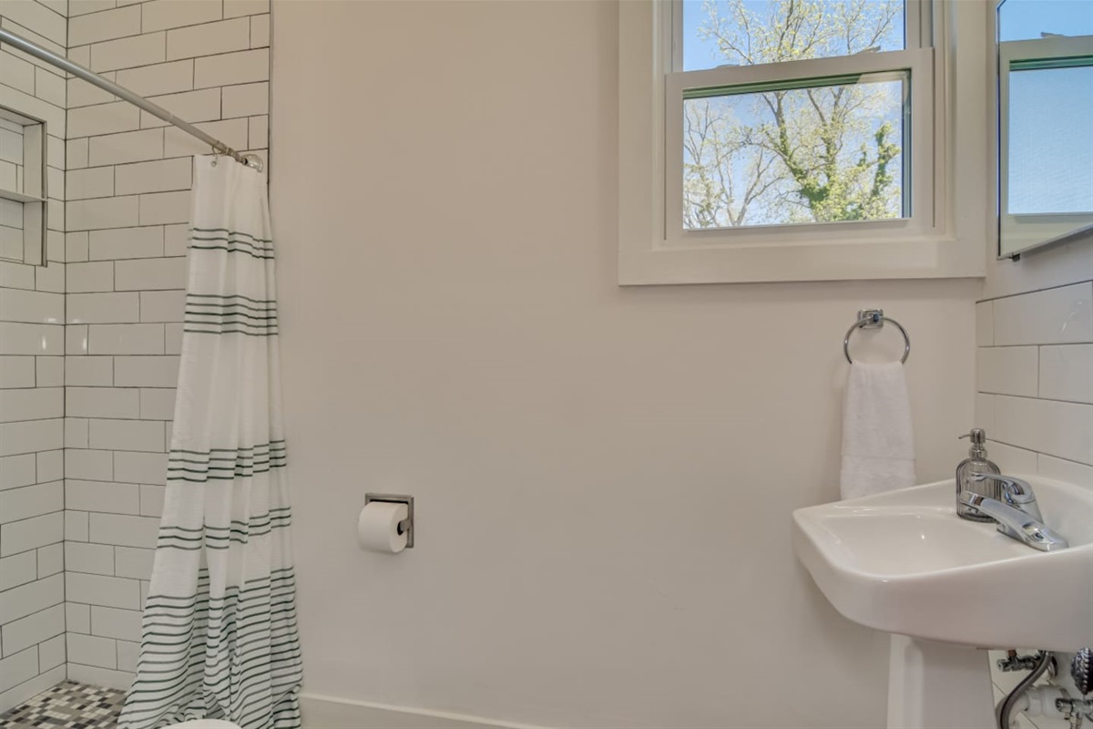Full bathroom with walk-in shower and modern finishes.