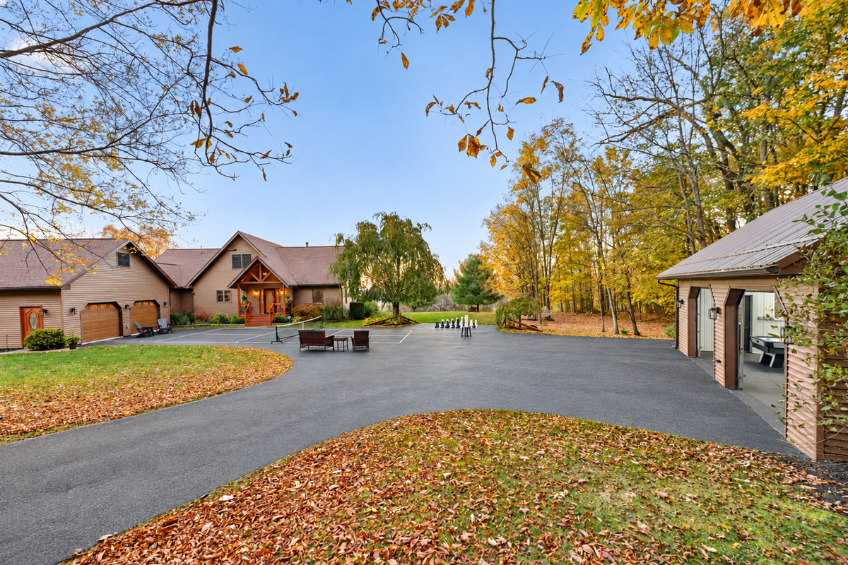 Expansive paved driveway surrounded by autumn trees