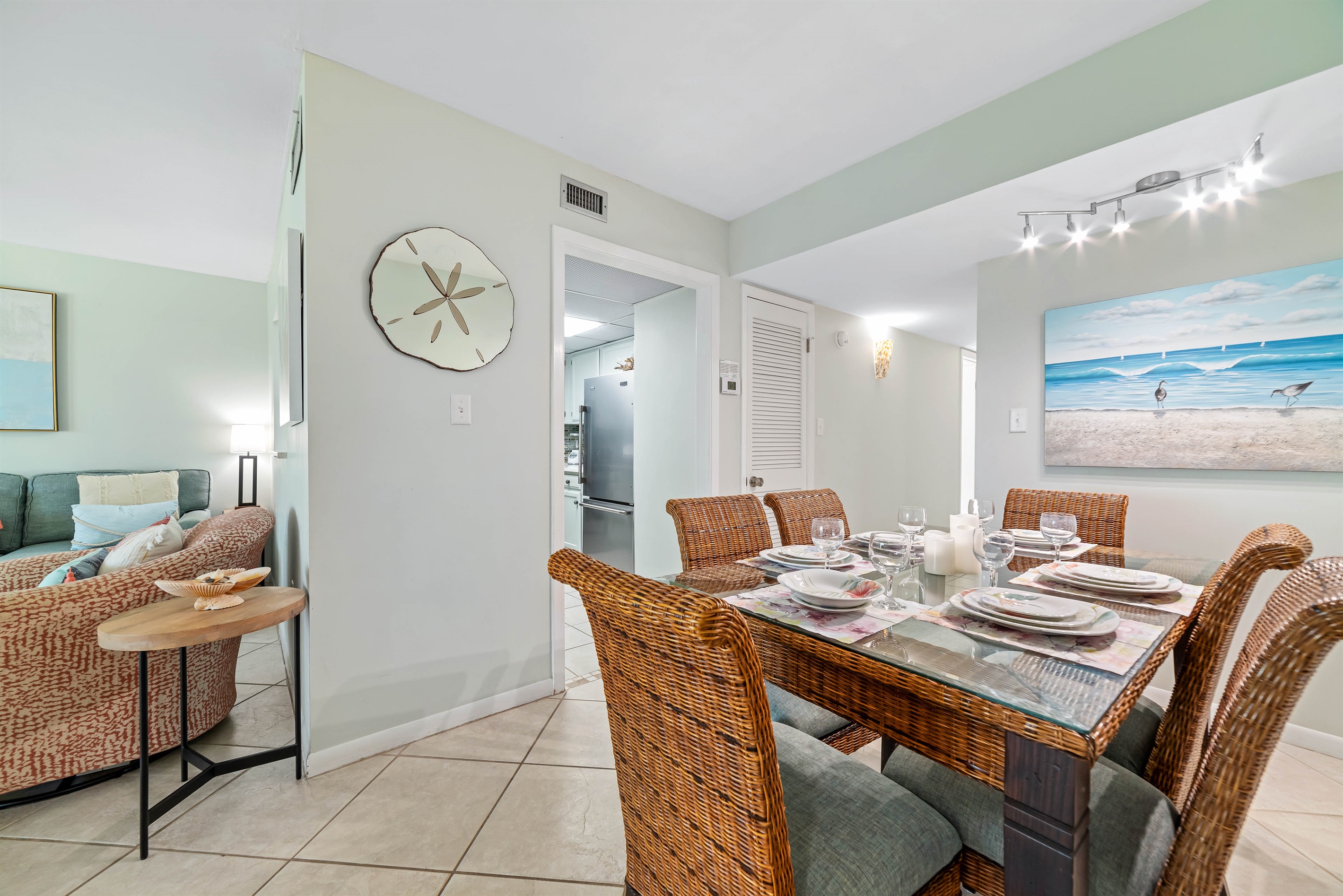 Dine in style with ample space for everyone. This inviting dining area features a charming table for family meals, complemented by additional seating at the convenient breakfast bar.