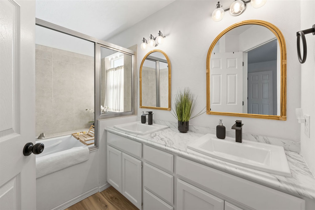 Primary bathroom has dual sinks and built in jacuzzi tub