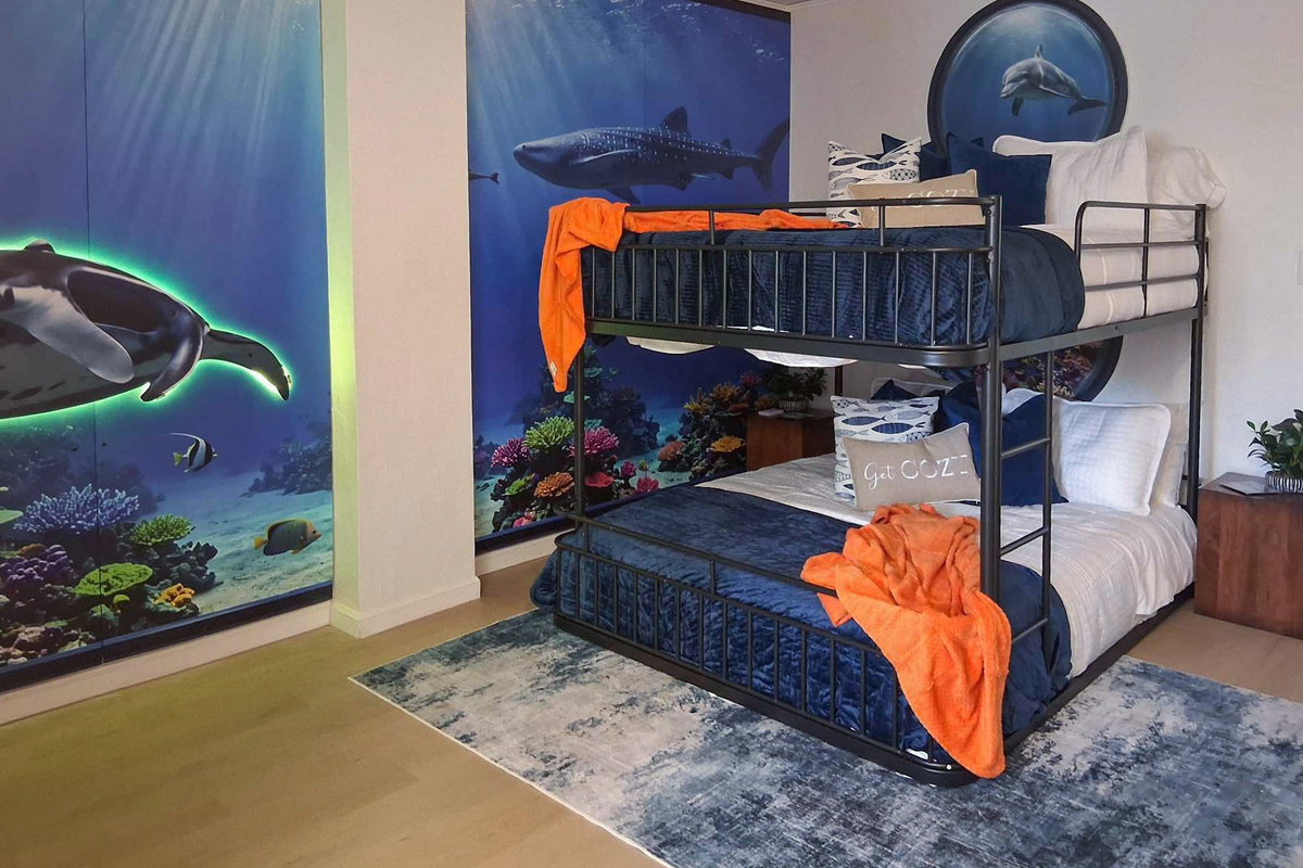 The fourth bedroom is the Aquarium room, including queen bunk beds and twin bunk beds, sleeping up to 6 people comfortably.