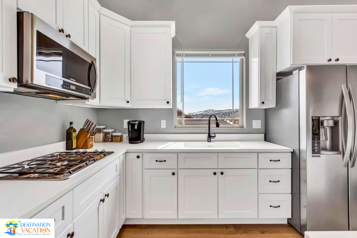 Bright kitchen combines elegant finishes with mountain views.