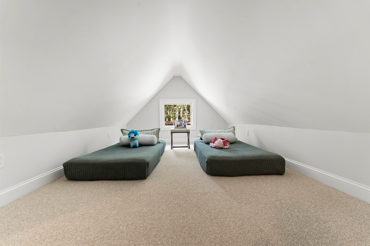 With a queen and two twin beds, this bedroom  offers space and flexibility for guests of all ages.