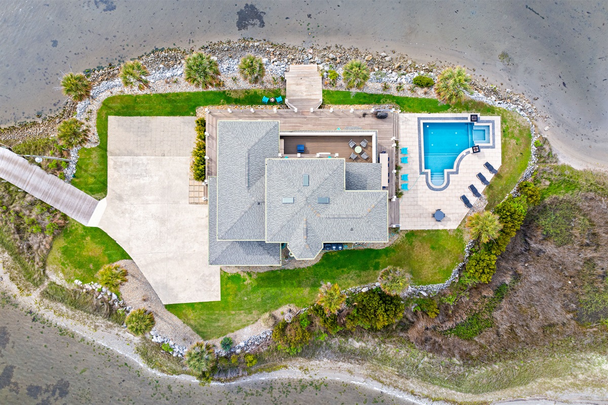 Bird&rsquo;s-eye view of this stunning waterfront estate featuring private pool, spacious decks, and direct water access