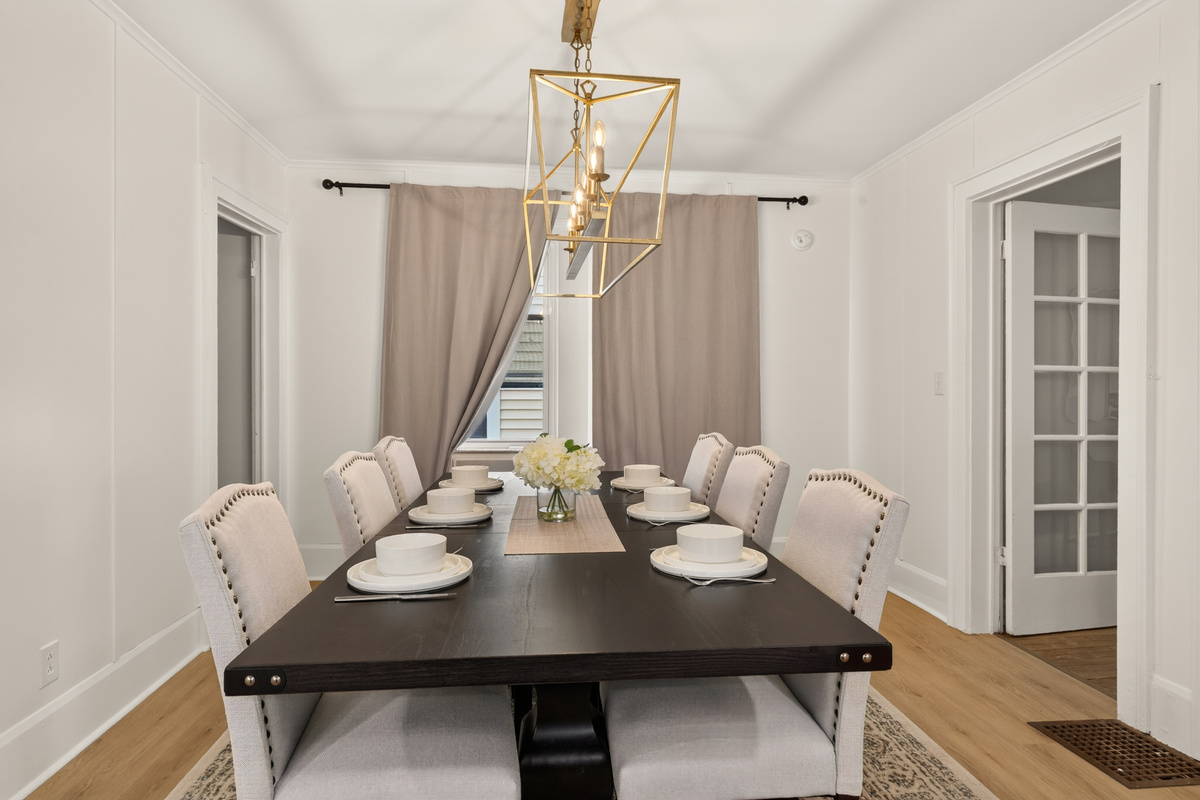 Dining table beneath a rectangular light fixture