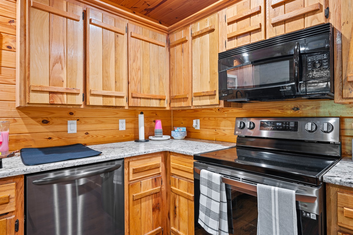 Fully stocked kitchen featuring stainless steel appliances, double sink, and plenty of cabinet space for meal prep.