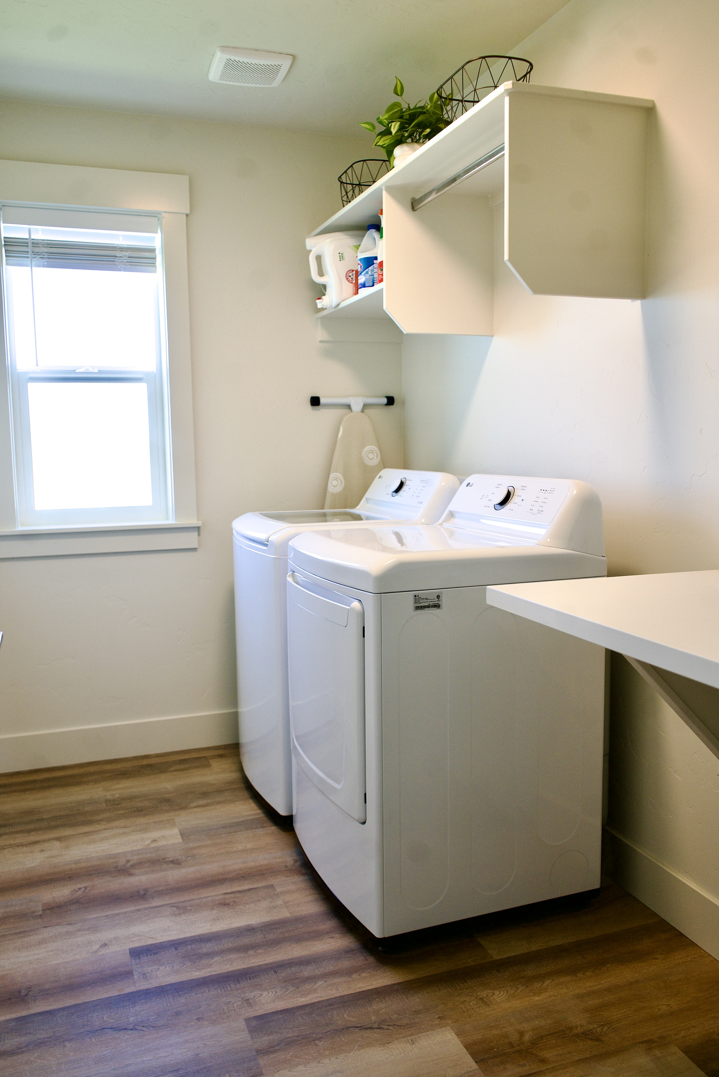 Upstairs, there is a spacious laundry room featuring a convenient folding table, providing added functionality and ease for longer stays.