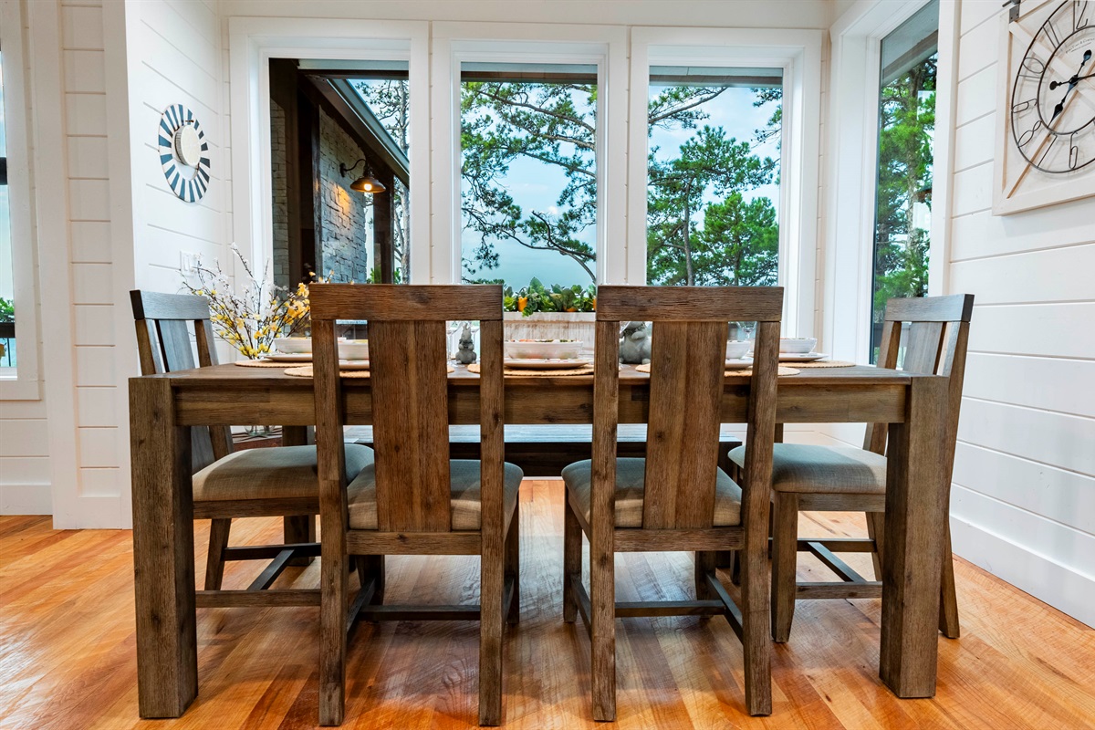 Cozy dining space with large windows bringing the outdoors inside